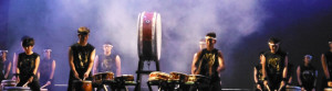 student taiko drummers on stage with theater fog curling around the drums