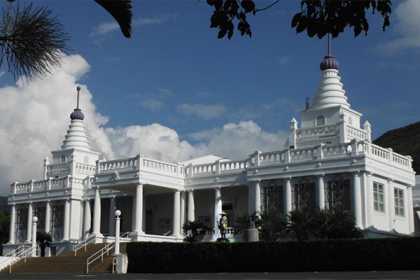 white temple building with blue sky background; photo by David Atcheson