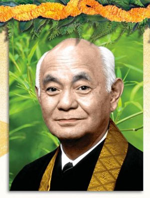 Rev. Chikai Yosemori with backdrop of greenery