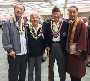 Veterans Reverend Yoshiaki Fujitani, Yoshinobu Oshiro, and Herbert Yanamura, all wearing lei, with Bishop Eric Matsumoto