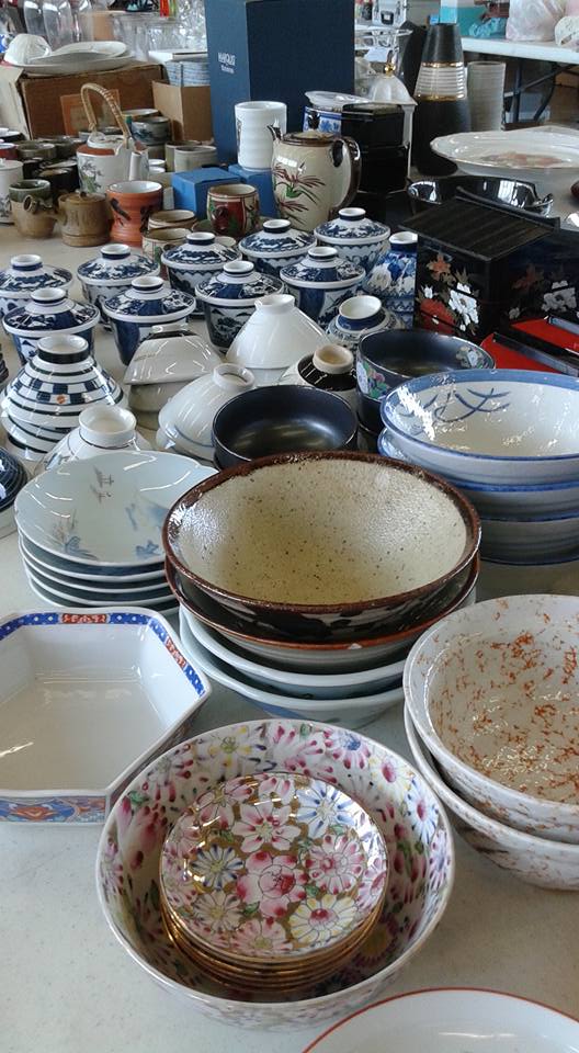 elegant Japanese dishes arranged on a rummage sale table