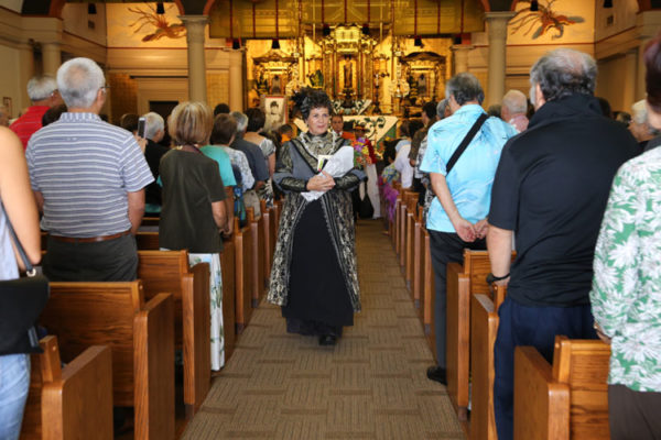 Queen Liliuokalani as portrayed by Jackie Pualani Johnson leads the recessional at the close of the Tribute Service