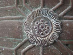 closeup of floral design on temple bell