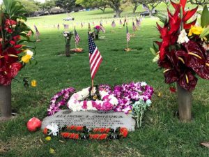flag and lei adorn grave of Ellison Onizuka