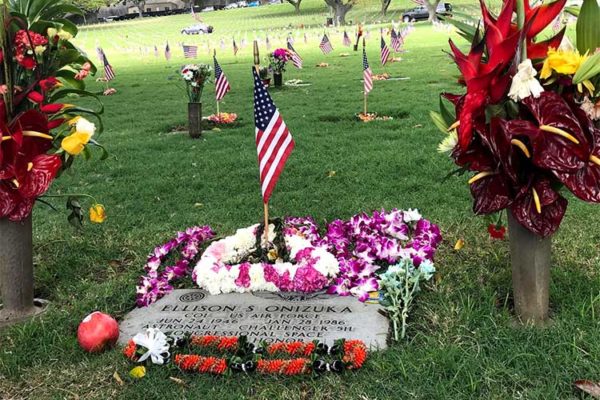 flag and lei adorn grave of astronaut Ellison Onizuka at National Cemetary of the Pacific
