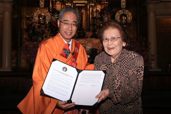 Bishop Matsumoto presents Lily Horio a resolution of appreciation adopted at Giseikai 2019. Photo: Lenscapes Photography