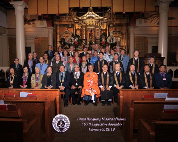 HHMH Board of Directors before the Betsuin altar with Bishop Matsumoto seated front, center in orange robes (2019 photo)