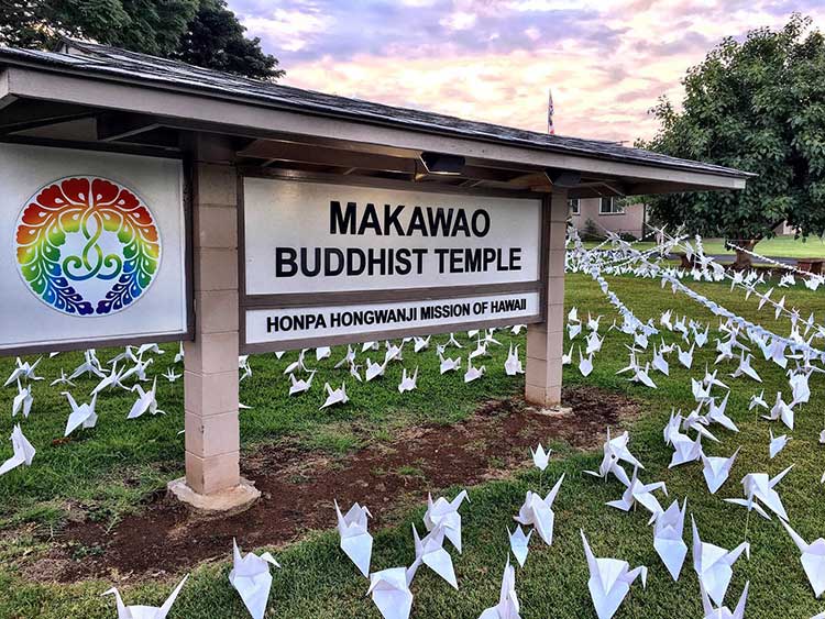 Thousands of origami peace cranes with Makawao Buddhist Temple sign