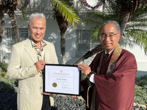 Kenny Endo receives Living Treasures of Hawaii award certificate from Bishop Eric Matsumoto