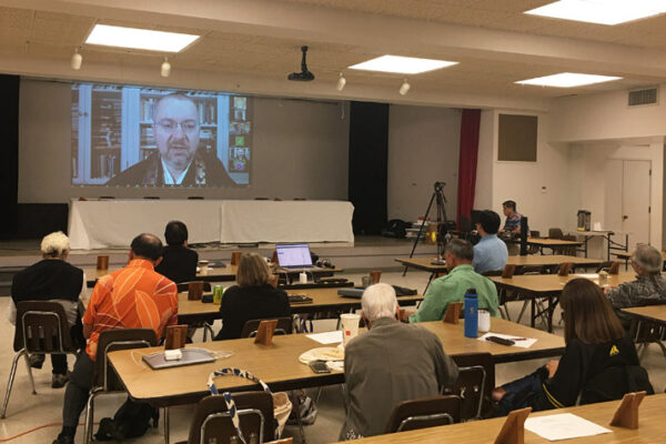 Rap Session with Dr. Jeff Wilson (projected on screen via Zoom) prior to the 2024 Legislative Assembly