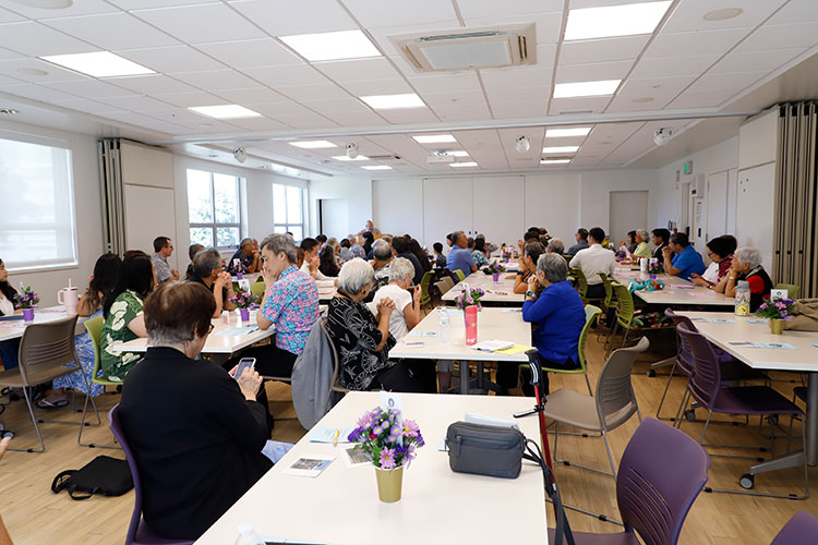 Large meeting room with people seated at tables